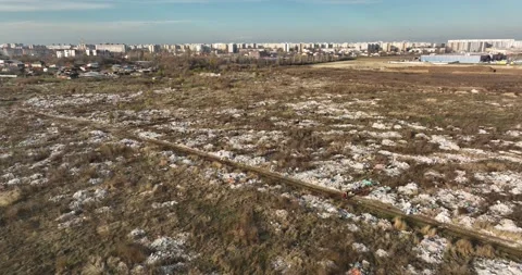 Two people walking on a huge aste, garbade, dump, rubbish landill in Bucharest Stock Footage 198212470