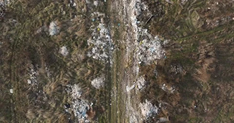 Two people walking on a huge aste, garbade, dump, rubbish landill in Bucharest Stock Footage 198212984