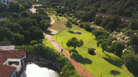 Two people walking on the lawn Stock Footage 157562083