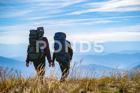 The two people walking on the mountain Stock Photos