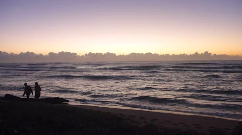Two People Walking Ocean Beach at Sunrise Stock Footage 45530318