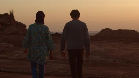 Two People Walking In Slow Motion On Dirt During Sunset Stock Footage 133005039