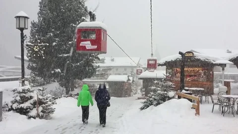 Two people walking under a heavy snowfall Stock Footage 84681423