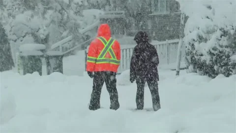 Two people walking under heavy snow. Stock Footage 146713383