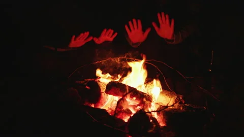 Two people warm their hands by fire on cold night Stock-Footage 175773517