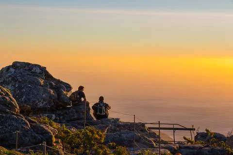 Two people watching sunset on table mountain Stock Photos