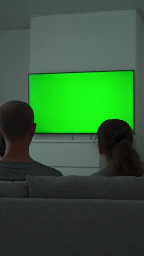 Two people watching tv with green screen at home Stock Footage 337558547