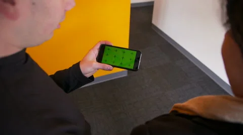 Two People Watching Video on iPhone 6 Green Screen Video stock 46080292