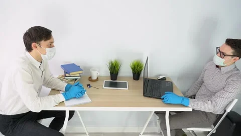 Two people workers, keep social distance on working place, discuss. Lockdown. Stock-Footage 131471413