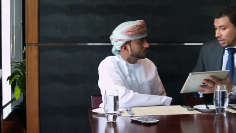 Two people working on a digital tablet in a restaurant Stock Footage 70103068