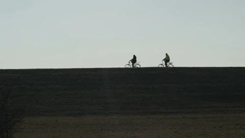 Two peoples on bicycles in winter Stock Footage 232597818