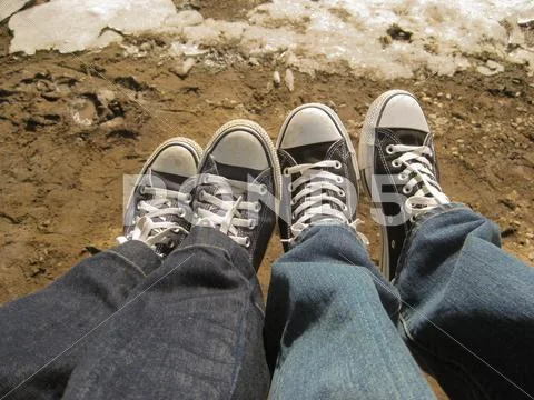 Two peoples feet showing love and togetherness between them both Stock Photos