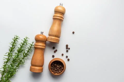 Two pepper mill on white background. Kitchen idea Stock Photos