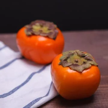 Two persimmons Stock Photos