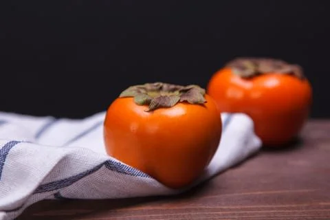 Two persimmons Stock Photos