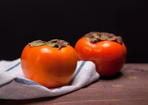 Two persimmons Stock Photos