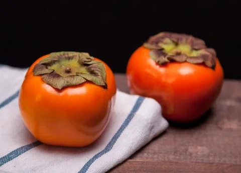 Two persimmons Stock Photos