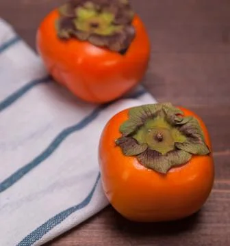 Two persimmons Stock Photos