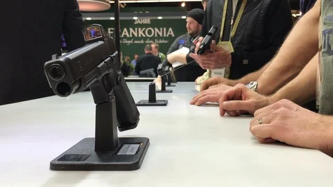 Two person discuss about firearms exhibition gun show Stockbeeldmateriaal 87198161