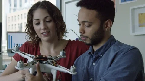 Two person portrait of engineering partners working on a robot. Stock Footage 82394563