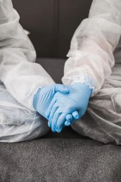 Two person in protective white translucent suit, blue rubber gloves, medical Stock Photos