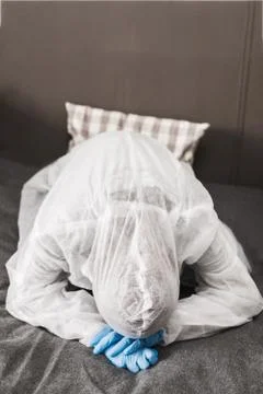 Two person in protective white translucent suit, blue rubber gloves, medical Stock Photos