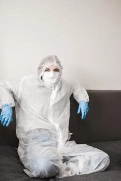 Two person in protective white translucent suit, blue rubber gloves, medical Stock Photos