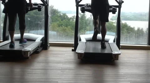 Two person running on the treadmill indoor Stock Footage 56831416