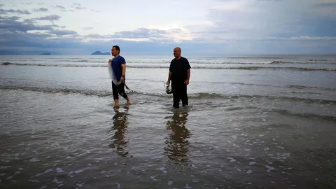 Two person walk at beach Stock Footage 99266284