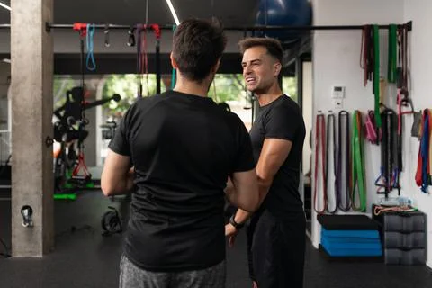 Two personal trainers talking to each other at the gym Stock Photos