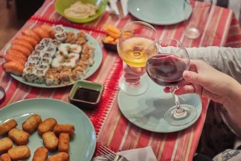 Two persons cheers in a table dinner Stock Photos