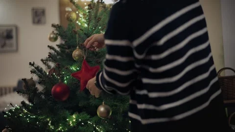 Two persons decorating the Christmas tree Stock Footage 259035164