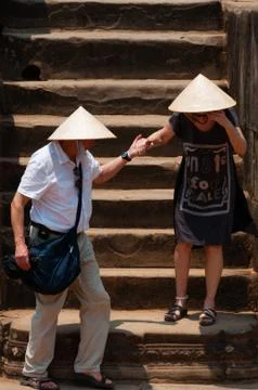 Two persons with hat climbing down stairs Stock Photos