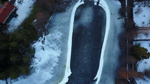 Two persons ice skating on frozen lake, filmed from above Stock Footage 76260869