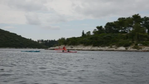 Two persons kayaking in the ocean Stock Footage 112742906
