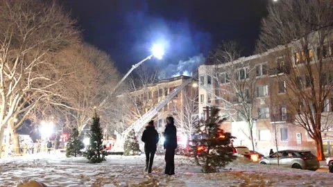 Two persons looking at apartment fire during christmas Stock Footage 139663860