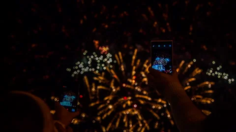 Two Persons Making Video Of Fireworks Using Smartphones Stock Footage 140243517