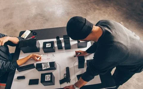 Two persons planning a heist Stock Photos