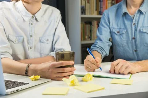 Two persons working at home office desk Stock Photos