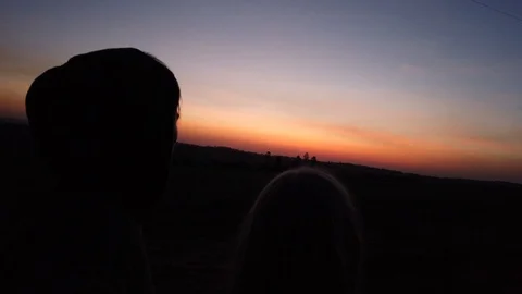 Two personsn looking into the sunset in south america Paraguay 스톡 동영상 117171076