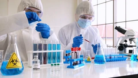 Two pharmaceutical testing vaccine for covid-19 Stock Footage 133097662
