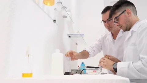 Two pharmaceutical workers invent new medicines in the laboratory Stock Footage 118120170