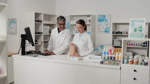 Two Pharmacists Preparing Orders in Pharmacy Stock Footage 334866296