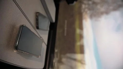 Two phones lie side by side on table in train carriage and on black screens 動画素材 309233725