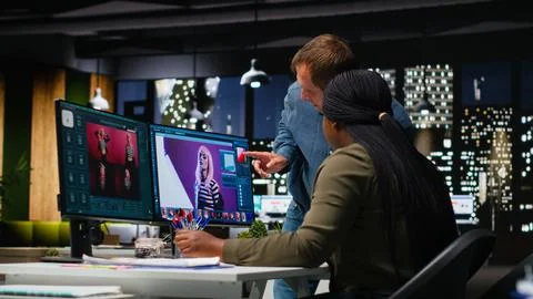 Two photo editors using AI tools and program for retouching Stock Photos