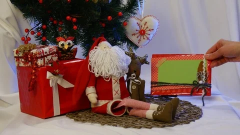 Two Photo Frames Are Taken Away From a Christmas Fir Tree With a Lot of Hand Stock Footage 72548764