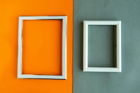 Two photo frames on geometric orange and grey background, copy space for the  Foto stock