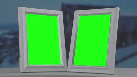 Two photo frames on window sill at home during blizzard and snowfall Stock Footage 252385191