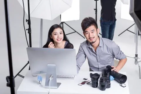 Two photographers working in studio with computer Stock-Fotos