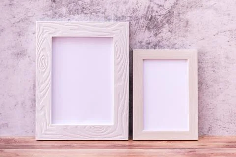 Two Picture frame on wall background and wooden table. Poster product design Stock Photos